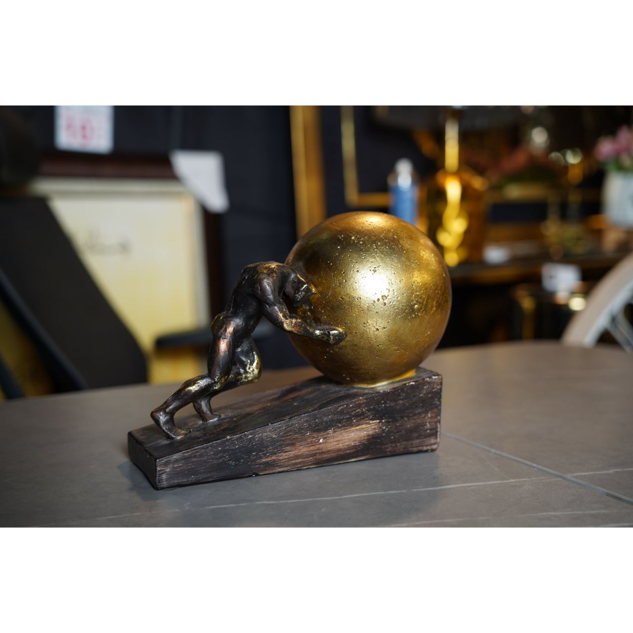 Determined Black Man Pushing Golden Ball Wooden Sculpture side view