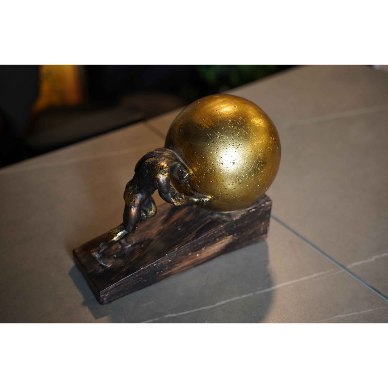 Determined Black Man Pushing Golden Ball Wooden Sculpture upper view